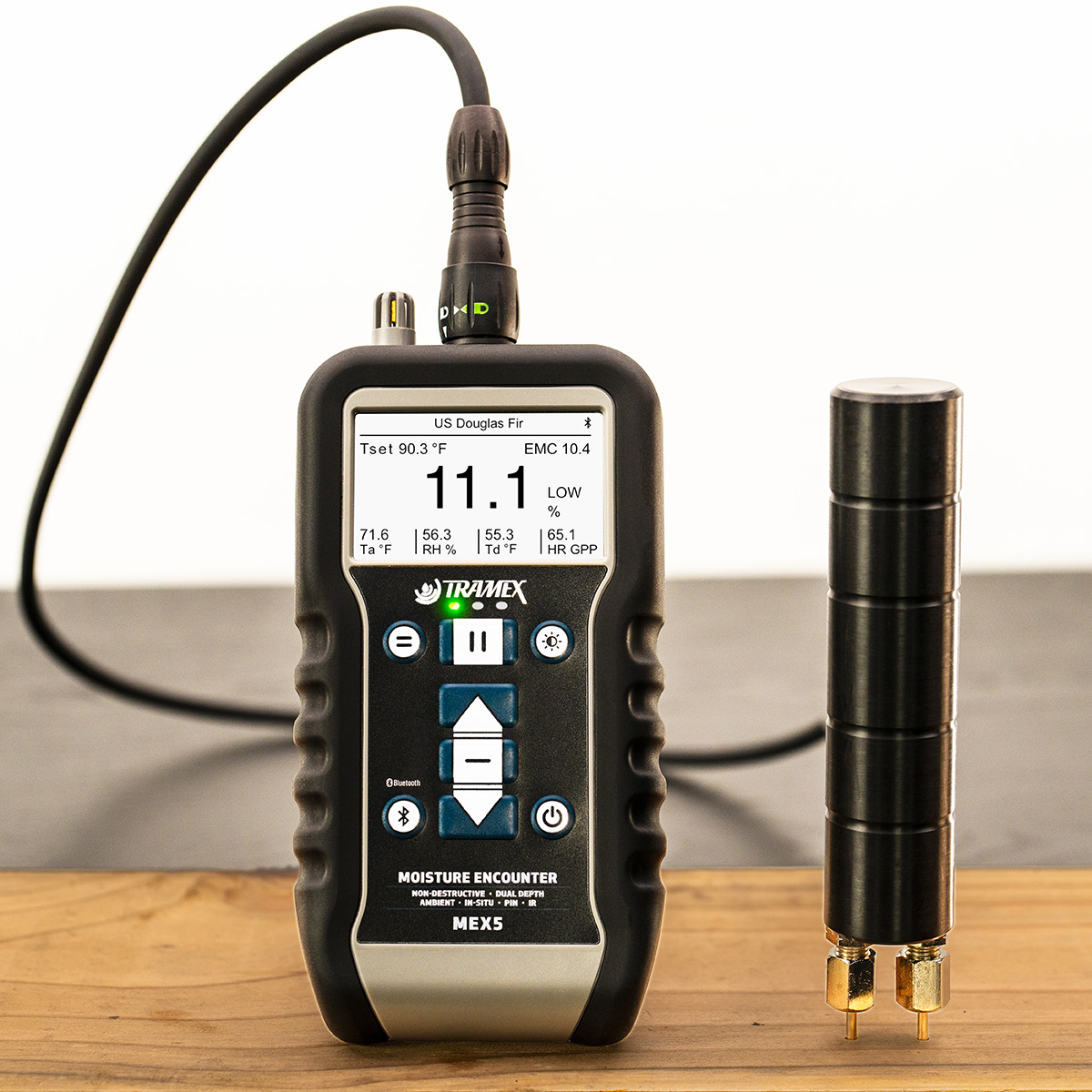 Measuring moisture content in floorboard with pin probe and Tramex Moisture Encounter MEX5